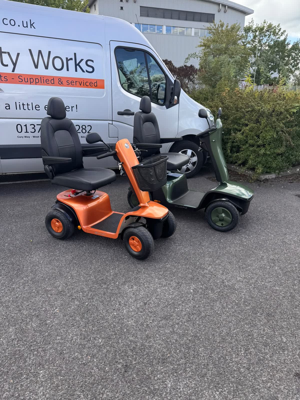 Vermeiren Sync in orange and Kuarz in green side by side outside the Mobility Works workshop